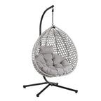Fauteuil suspendu polyvalent pour l'intérieur et l'extérieur, en rotin PE, avec support et coussin.