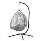 Fauteuil suspendu polyvalent pour l'intérieur et l'extérieur, en rotin PE, avec support et coussin.
