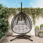 Fauteuil suspendu polyvalent pour l'intérieur et l'extérieur, en rotin PE, avec support et coussin.