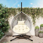Fauteuil suspendu polyvalent pour l'intérieur et l'extérieur, en rotin PE, avec support et coussin.