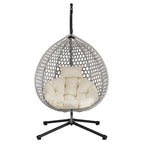 Fauteuil suspendu polyvalent pour l'intérieur et l'extérieur, en rotin PE, avec support et coussin.